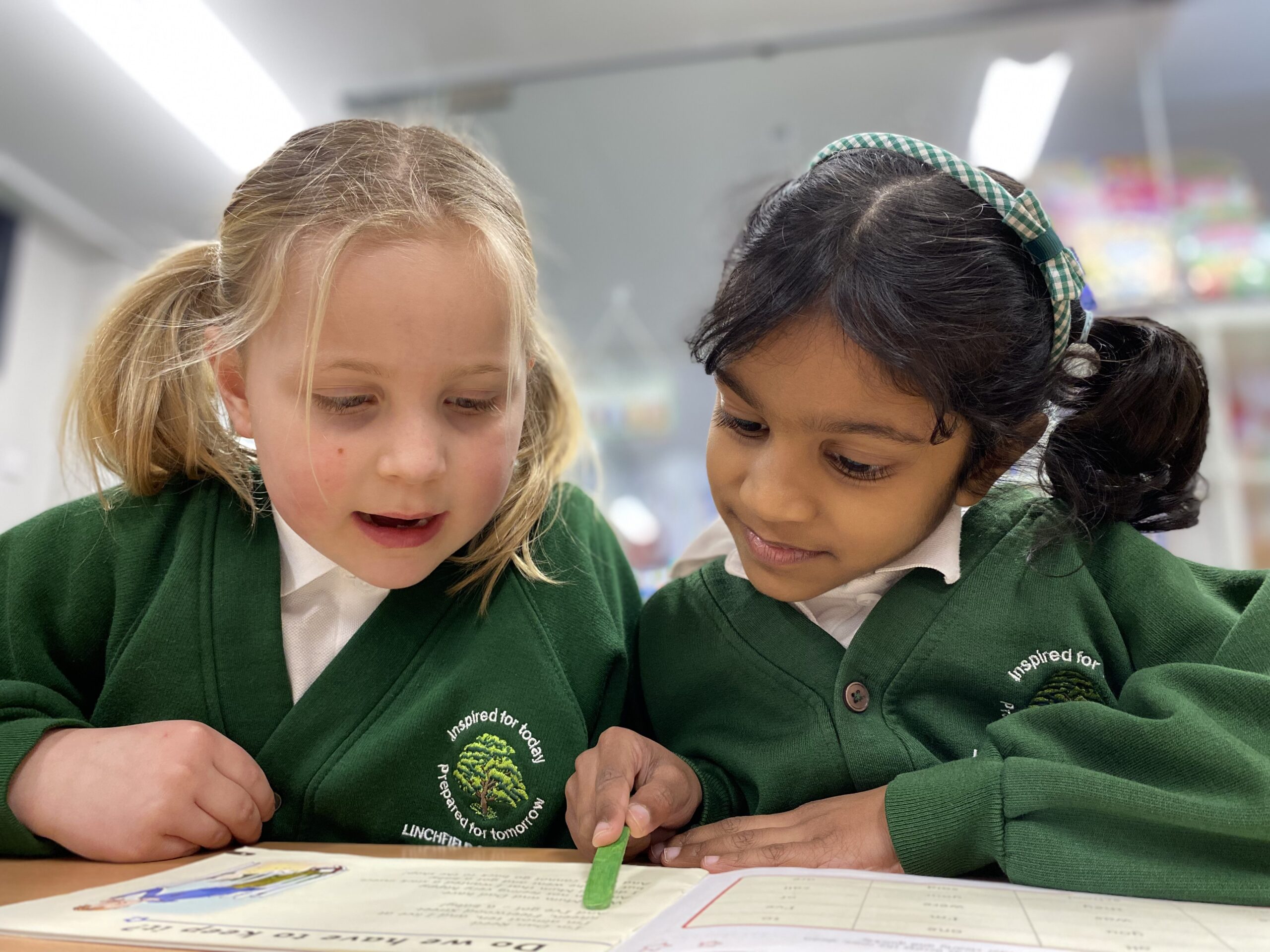 Linchfield Uniform pupils in uniform reading together