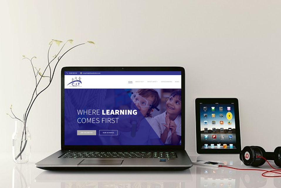 cropped-CIT-website-homepage.png a laptop on a desk showing the CIT website homepage