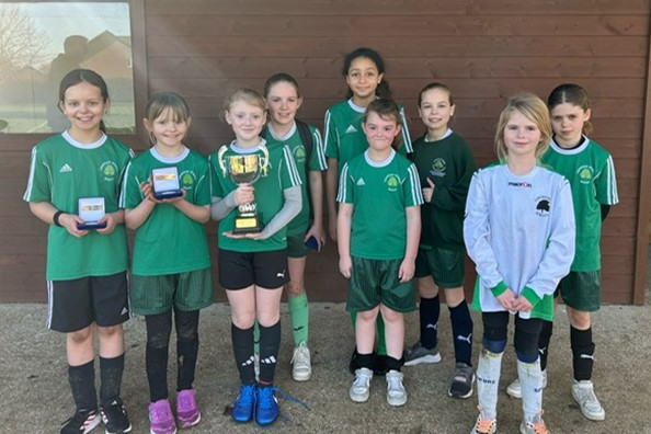cropped-Linch-Footy.png Pupils stand together having won football tournament