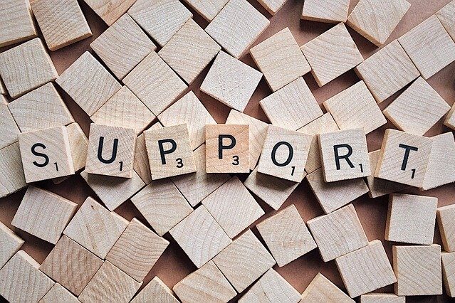 support Scrabble pieces spelling the word SUPPORT