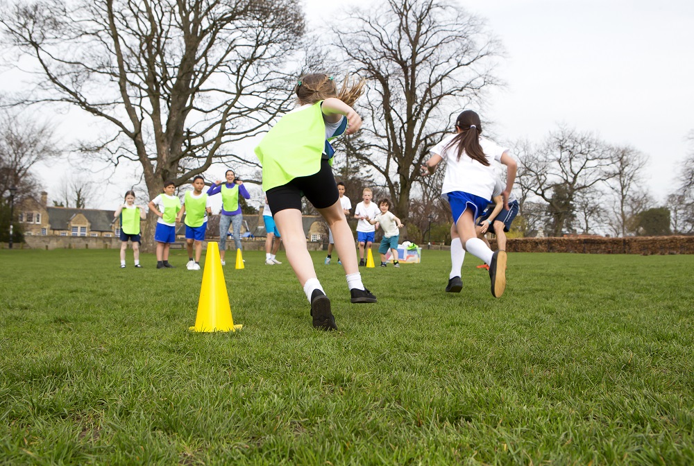 Sports children playing sport on the school field