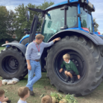 The children chat to Farmer Simon and look at the tractor